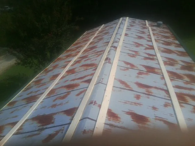 Rusted metal roof panels with new wood purlins before replacement — Storm Damage Roof Repair in Demarest by Roofing Brothers