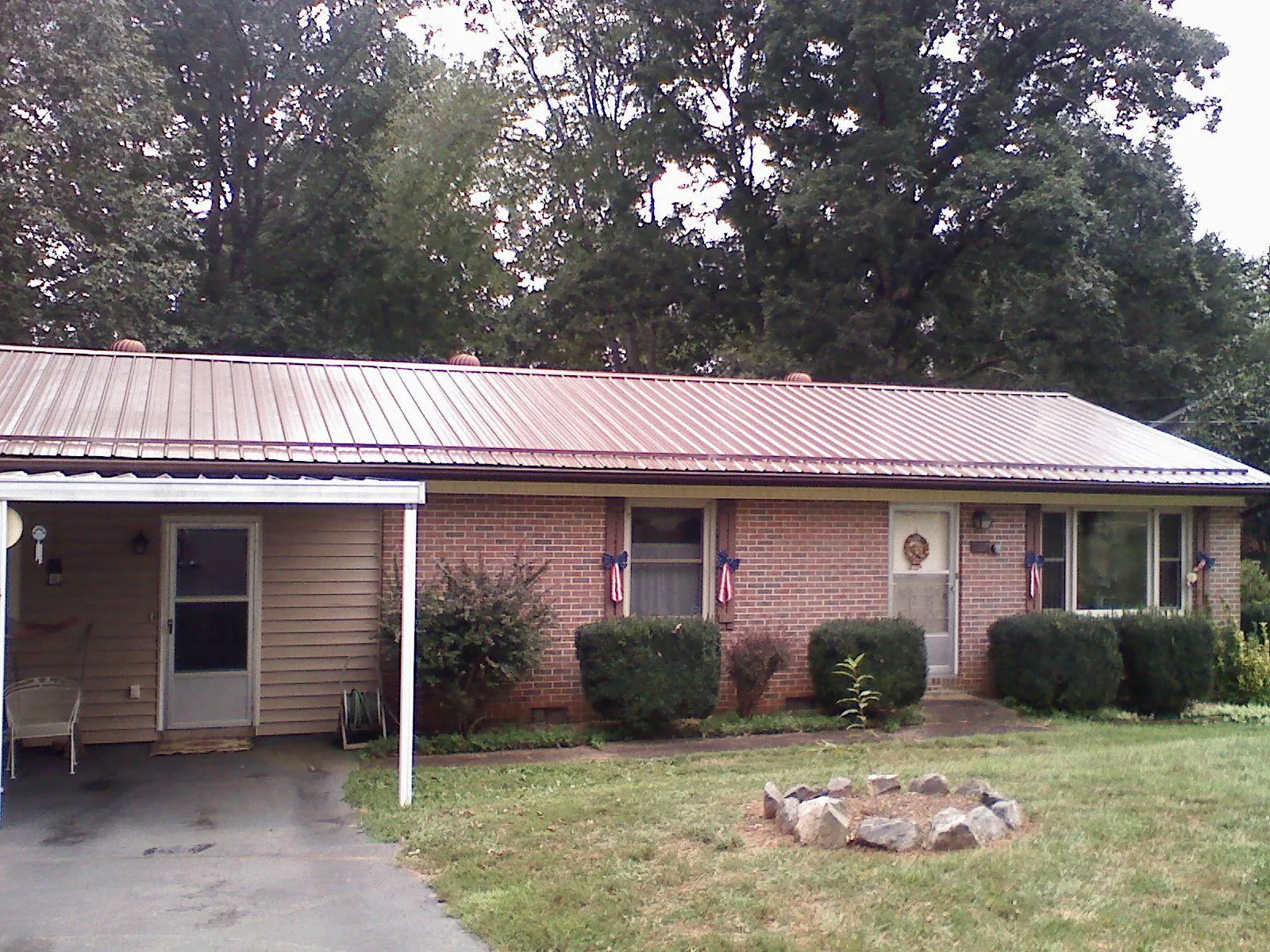 Bronze metal roof and carport on a brick ranch home — Roof Repair work by our crew in Demarest